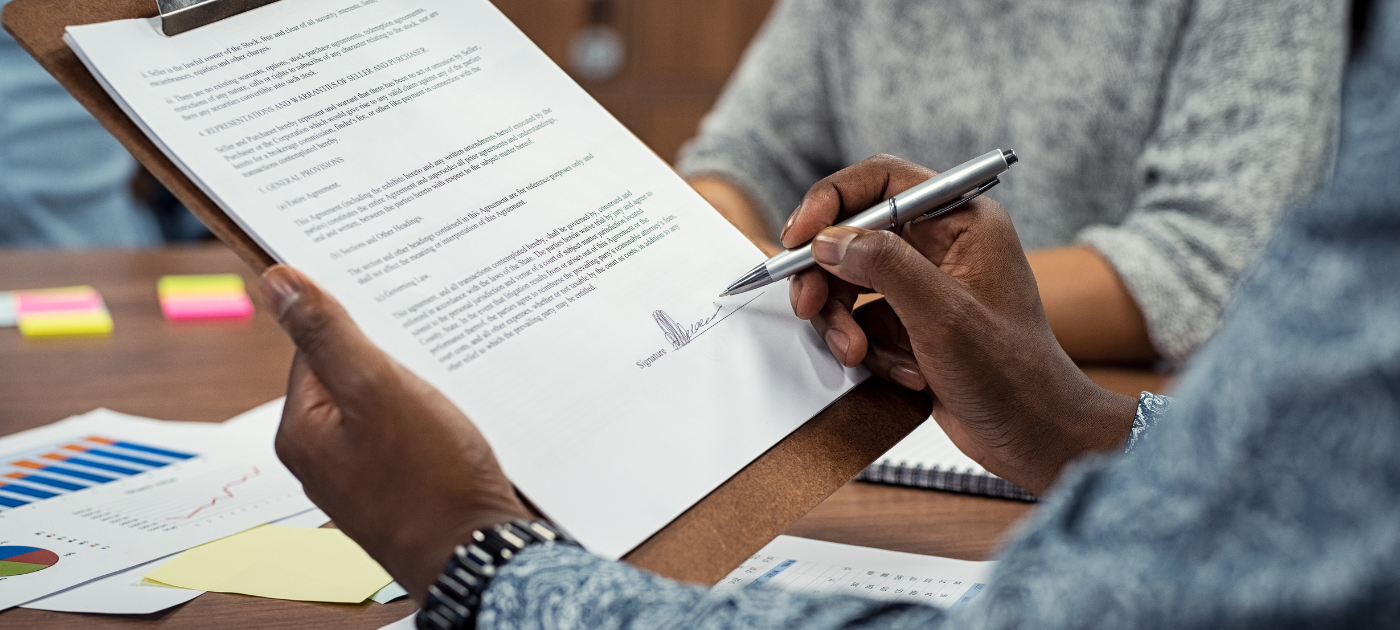 man signing a document - How to Dissolve an LLC in Georgia
