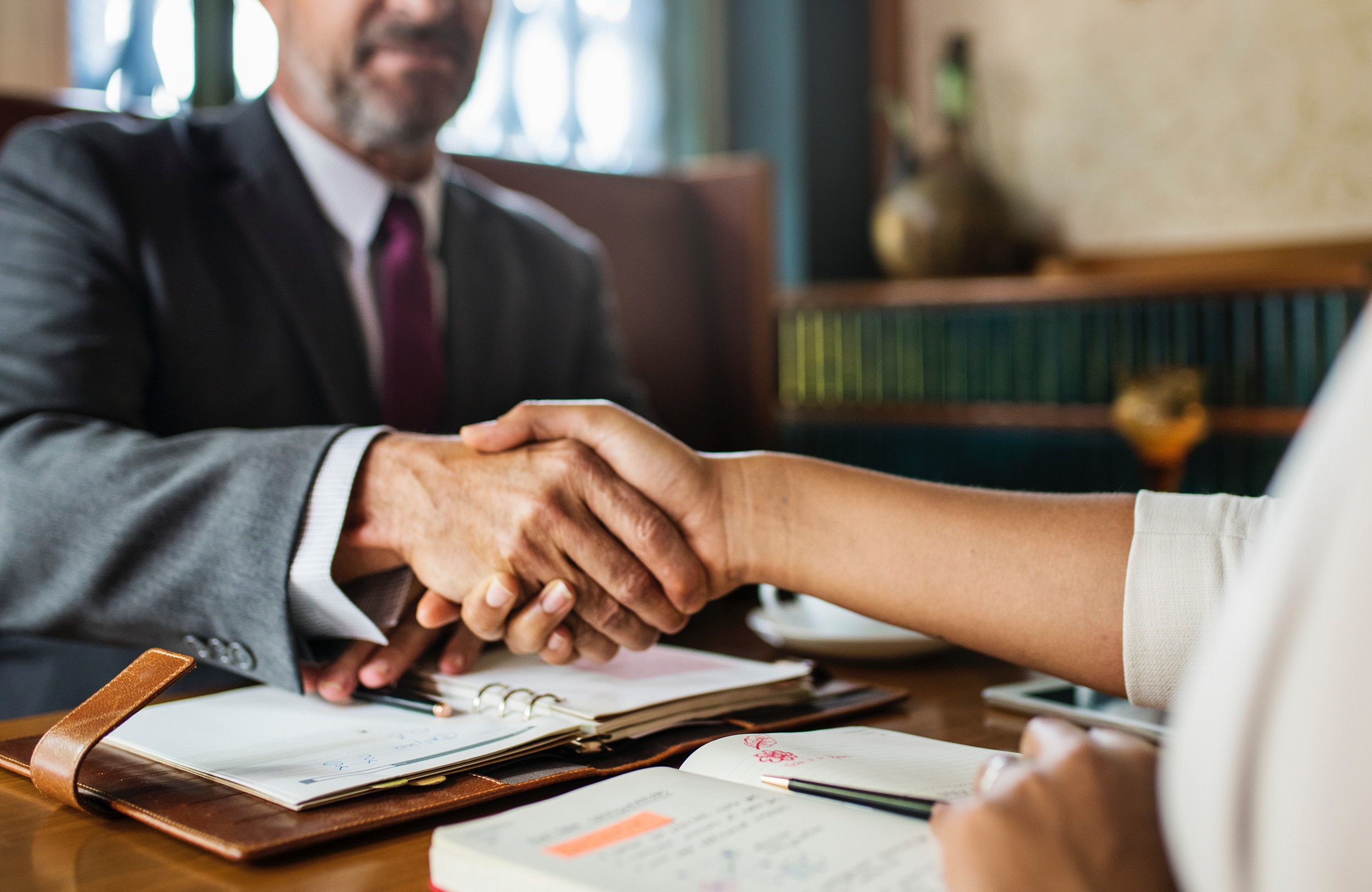 man shaking hands - How to Dissolve an LLC in South Dakota