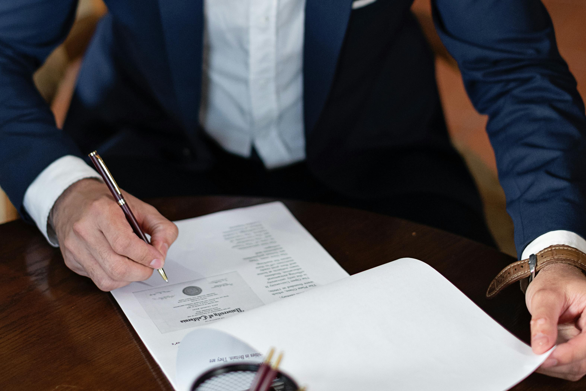 man signing document - How to Dissolve an LLC in Pennsylvania