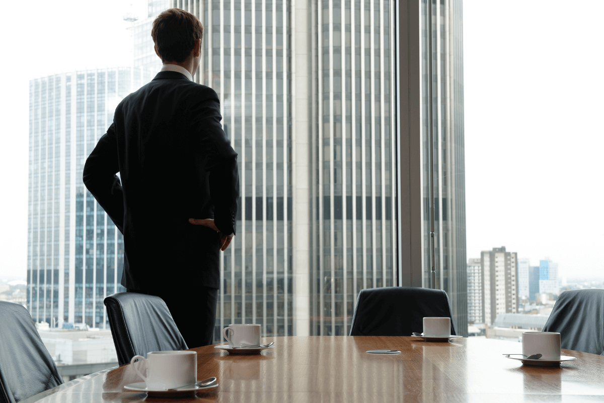 man looking out of window - How to Dissolve an LLC in Michigan