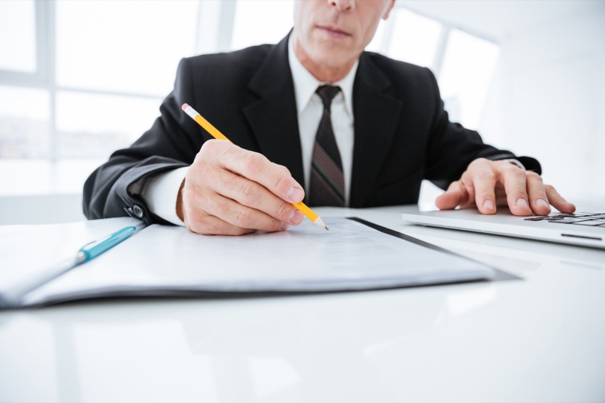 person making notes - How to Dissolve an LLC in Wisconsin 