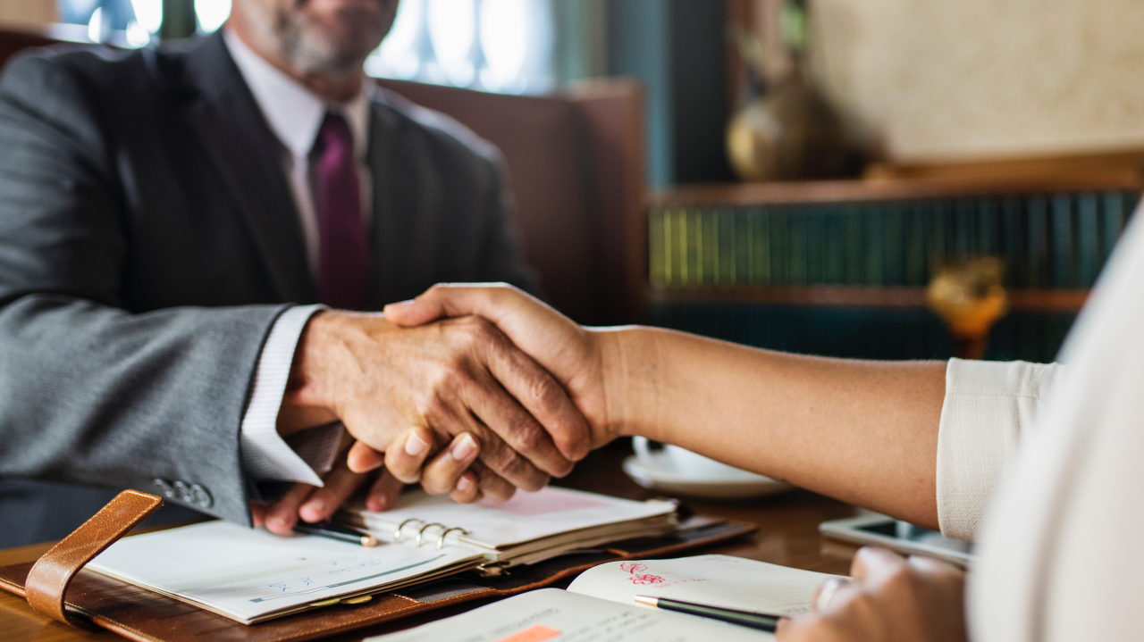 shaking hands - How To Dissolve An LLC In Vermont