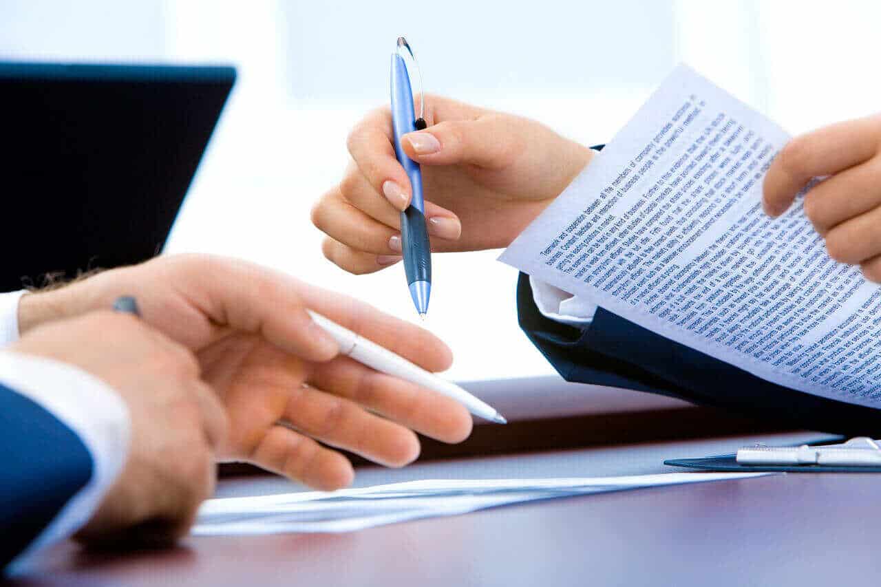 signing a document - How To Dissolve An LLC In Texas
