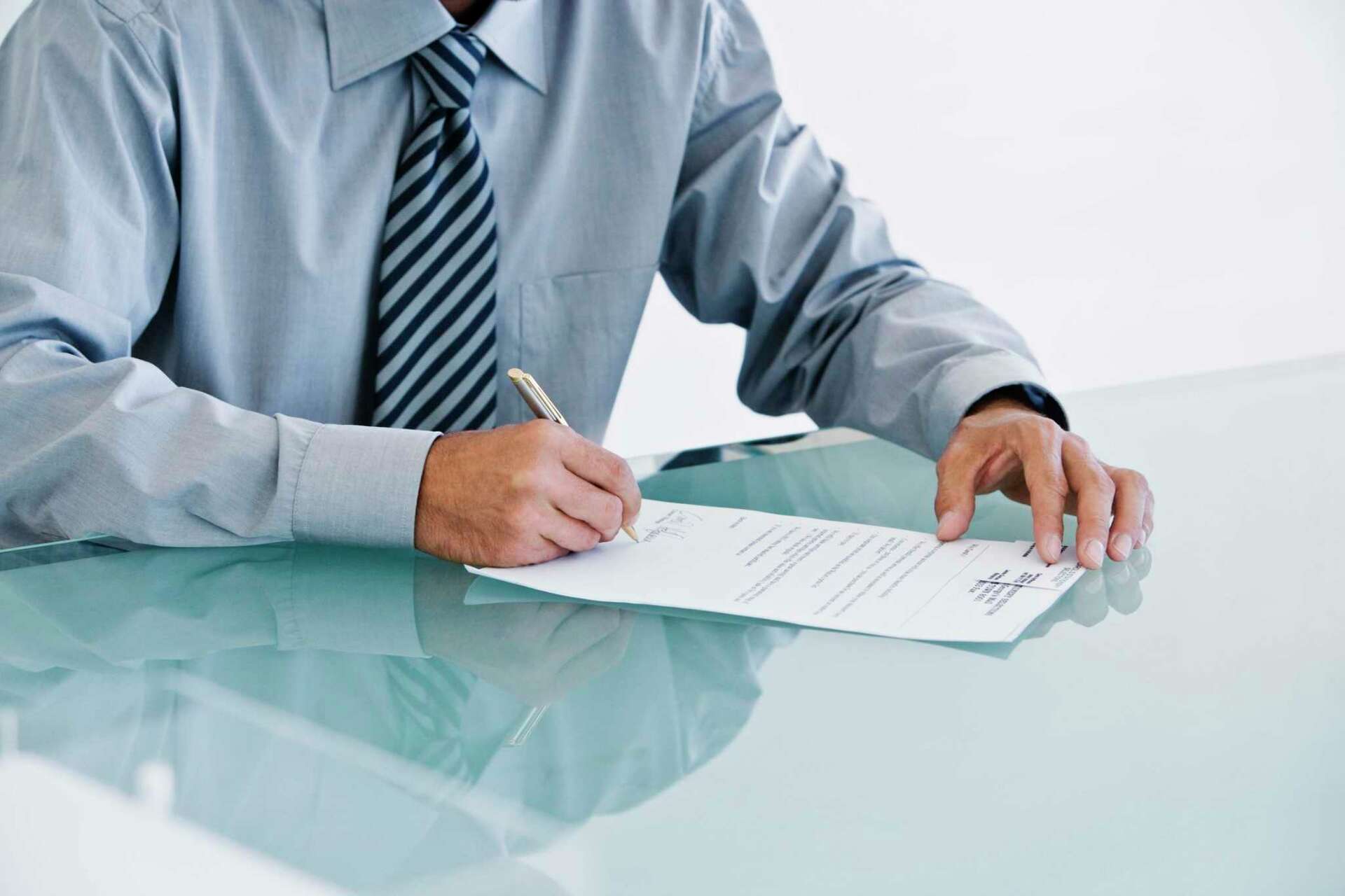 man signing document - How to Dissolve an LLC in New York