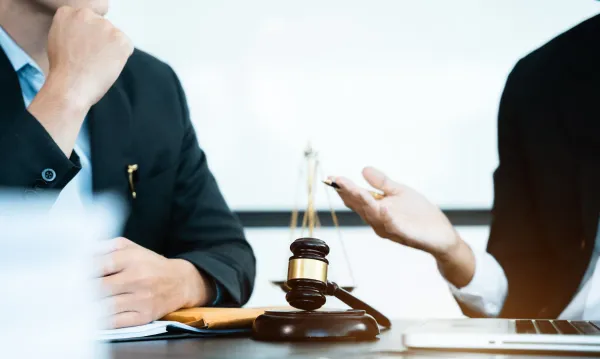 Person with his lawyer - How To Dissolve An LLC In Washington State